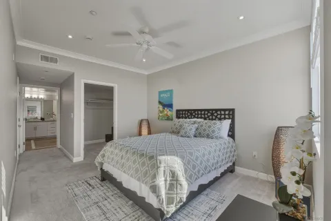 a bedroom with a large bed and a chandelier