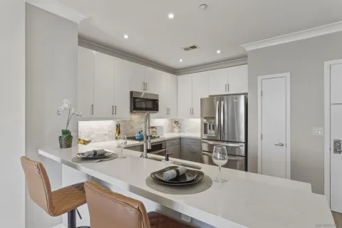 a kitchen with a refrigerator and a stove top oven