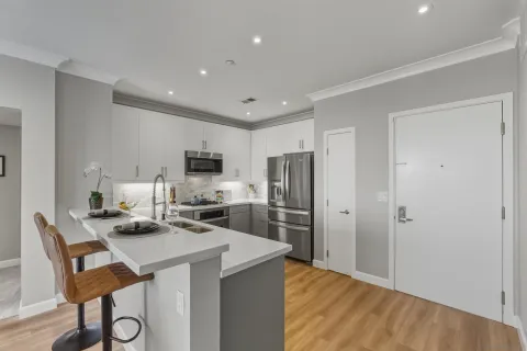 a kitchen with stainless steel appliances a refrigerator and a stove top oven