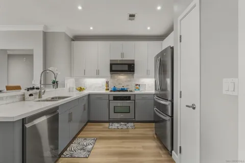 a kitchen with a sink cabinets and stainless steel appliances