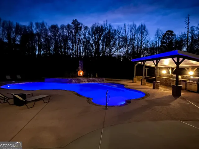 a view of a dining room with furniture a chandelier and wooden floor