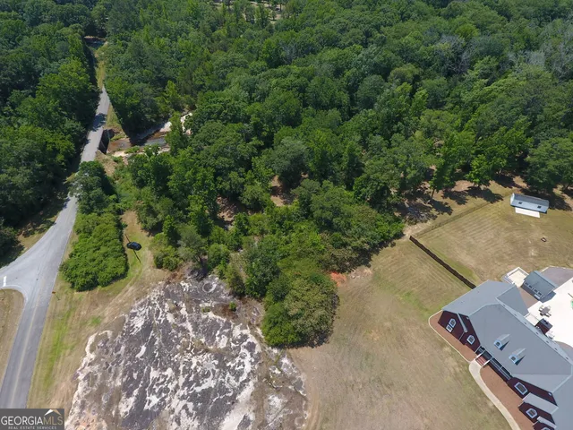 a spacious bedroom with a bed and a chandelier