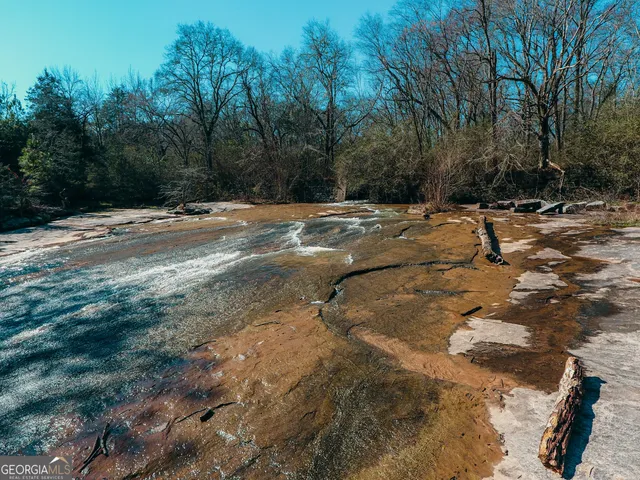 a living room with furniture gym equipment and a chandelier