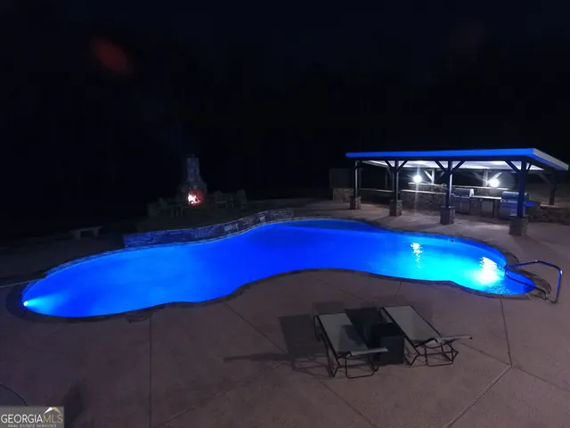 a kitchen with a dining table chairs and a refrigerator