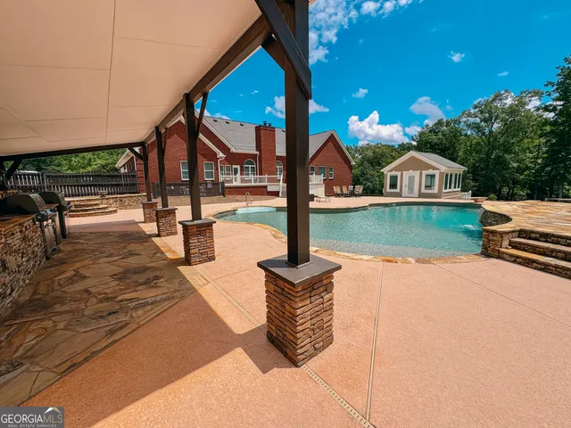 a view of a swimming pool with a yard