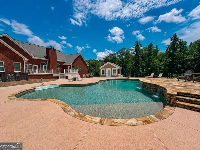 a view of a swimming pool with a patio