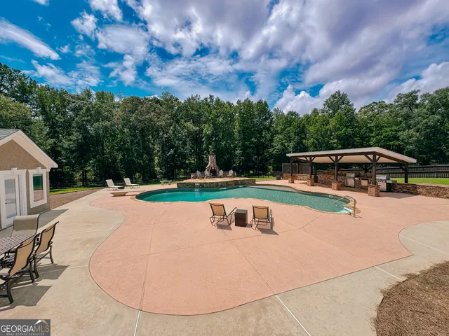 a view of a hallway with wooden floor and a living room