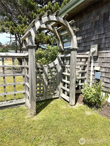 a view of a wooden house with a large tree in front of it