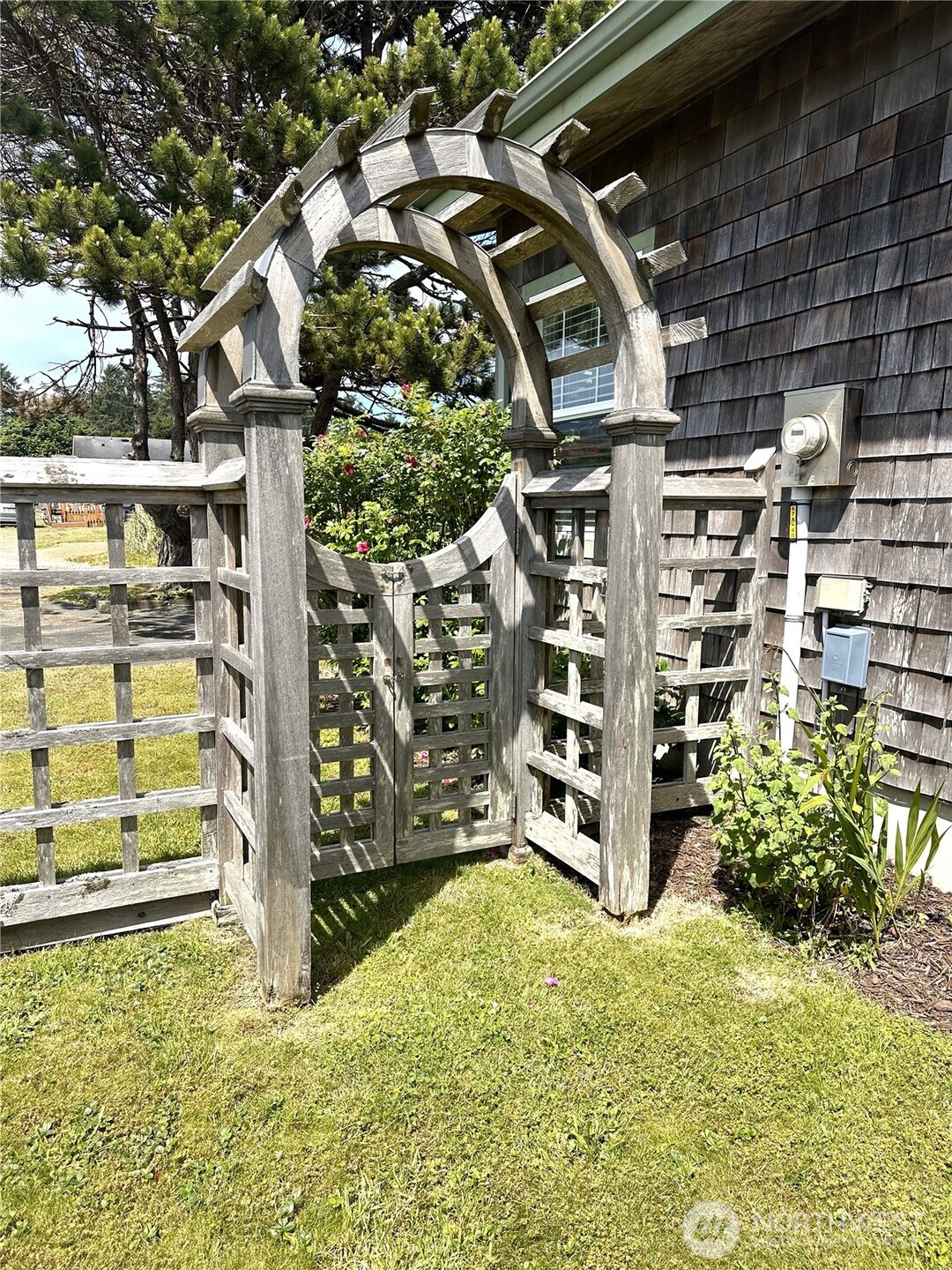 45 Central Avenue Pacific Beach, WA 98571 - Photo 15 of 28 a view of a wooden house with a large tree in front of it