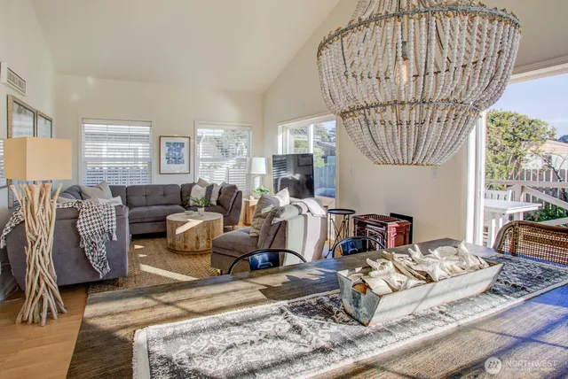 a living room with furniture a table and a chandelier