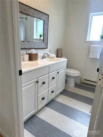a bathroom with a toilet sink and mirror