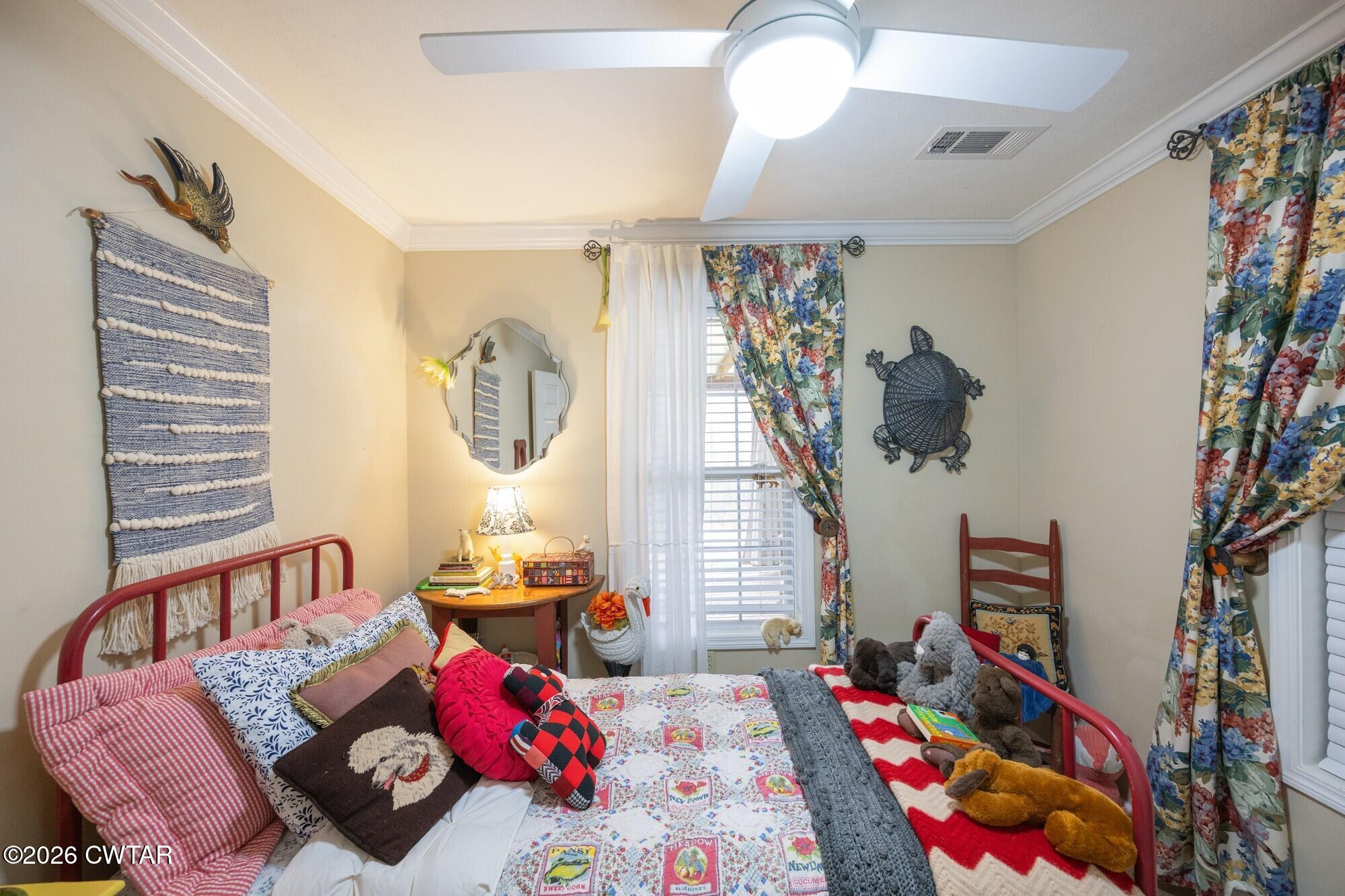 2108 Bohannon Landing Road Sugar Tree, TN 38380 - Photo 24 of 57 a bedroom with furniture and a book shelf