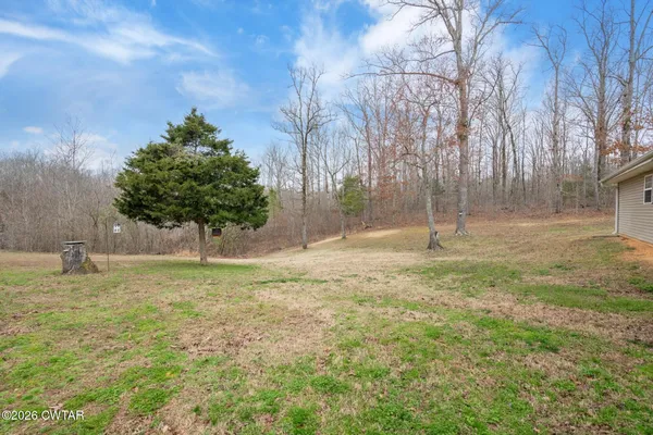 a view of a house with a yard and sitting area