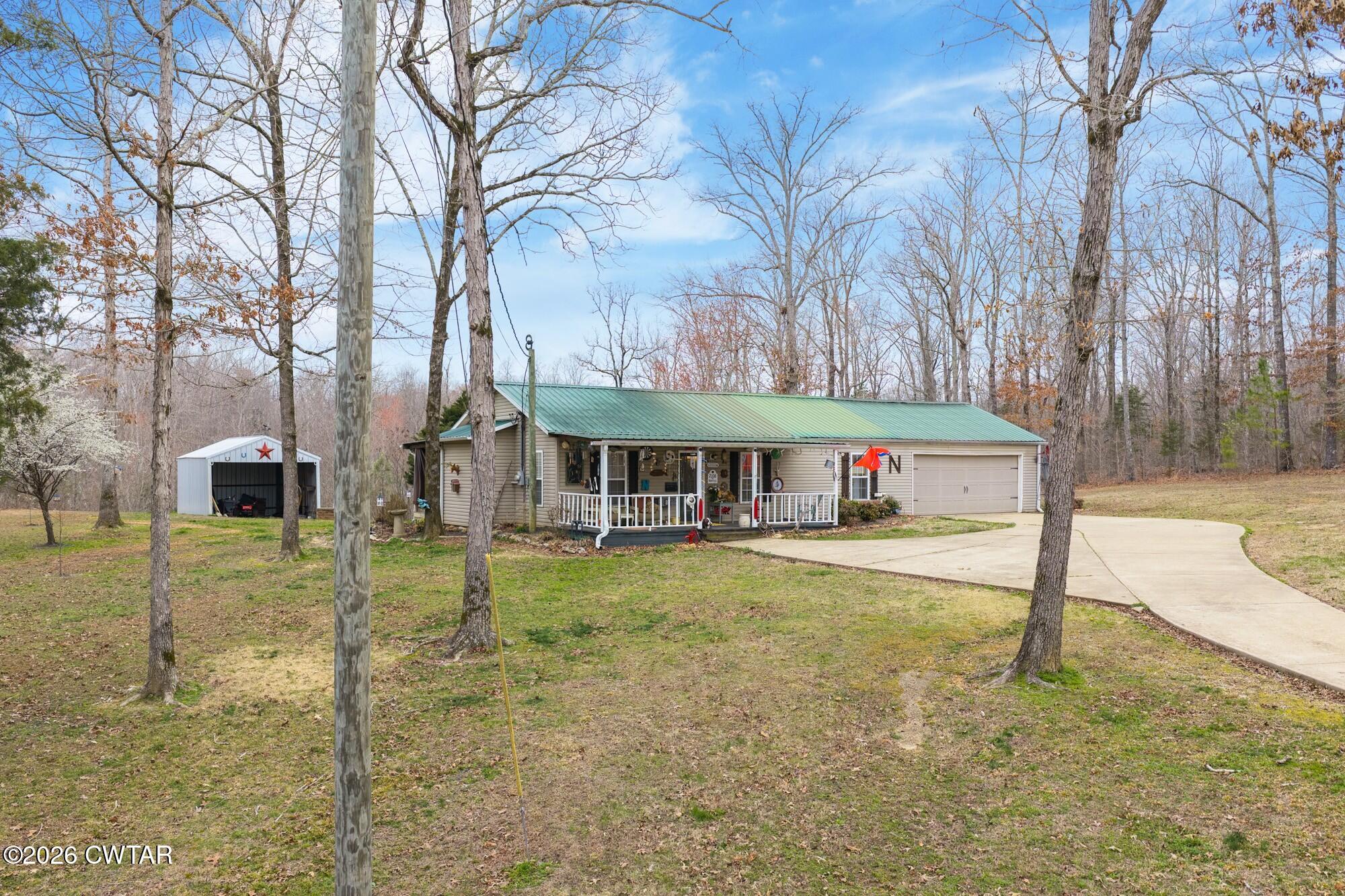 2108 Bohannon Landing Road Sugar Tree, TN 38380 - Photo 53 of 57 a backyard of a house with table and chairs