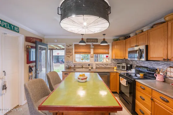 a kitchen with stainless steel appliances granite countertop a sink and cabinets