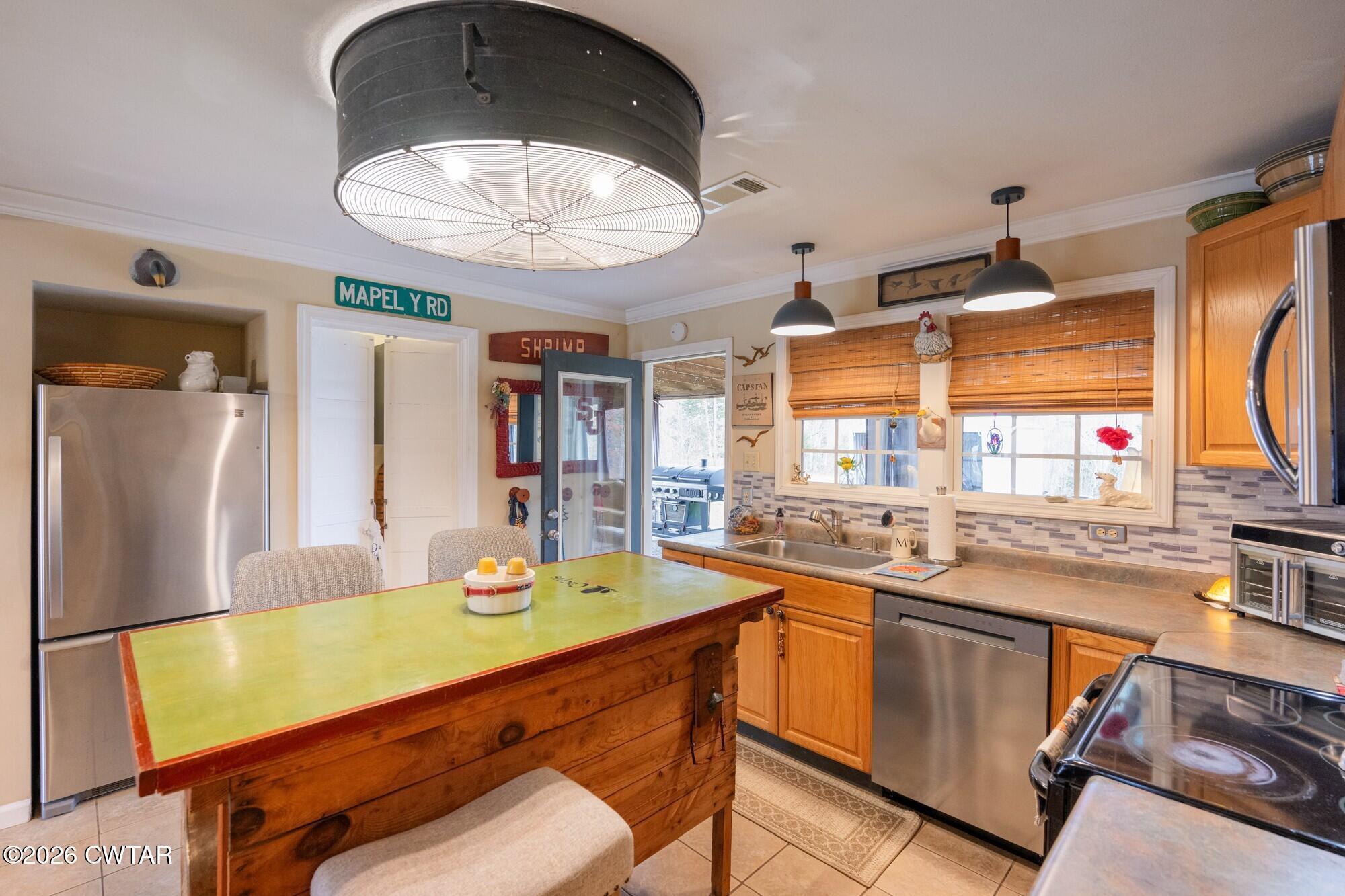 2108 Bohannon Landing Road Sugar Tree, TN 38380 - Photo 10 of 57 a kitchen with stainless steel appliances granite countertop a sink and cabinets