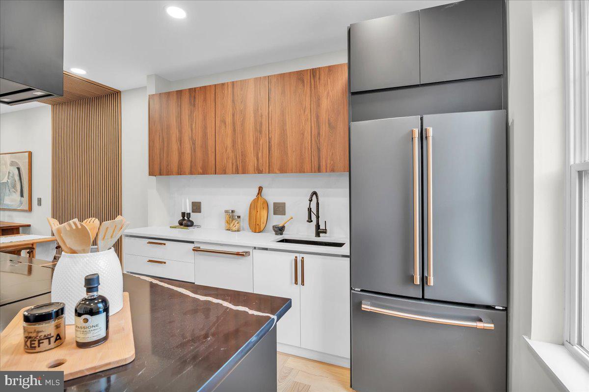 1227 Clymer Street Philadelphia, PA 19147 - Photo 11 of 37 a kitchen with stainless steel appliances granite countertop a refrigerator sink and cabinets