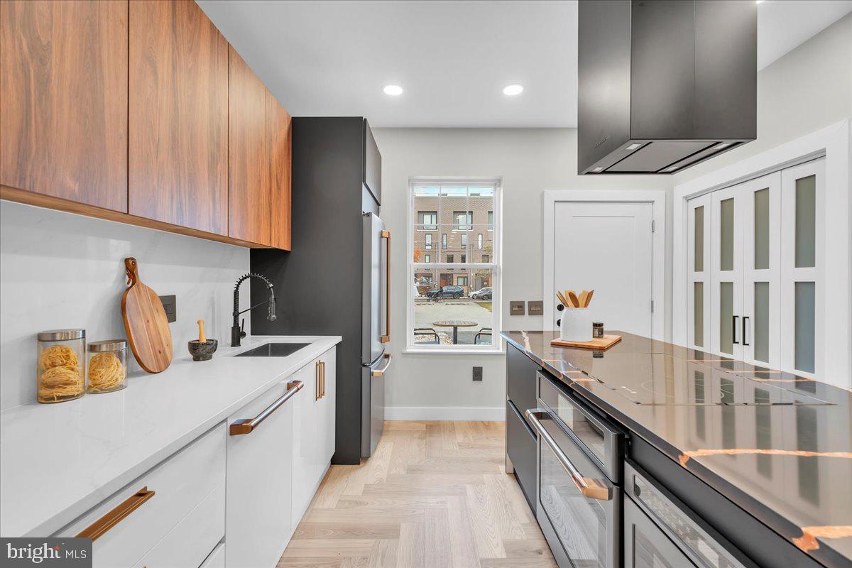1227 Clymer Street Philadelphia, PA 19147 - Photo 12 of 37 a kitchen with a sink stove and cabinets