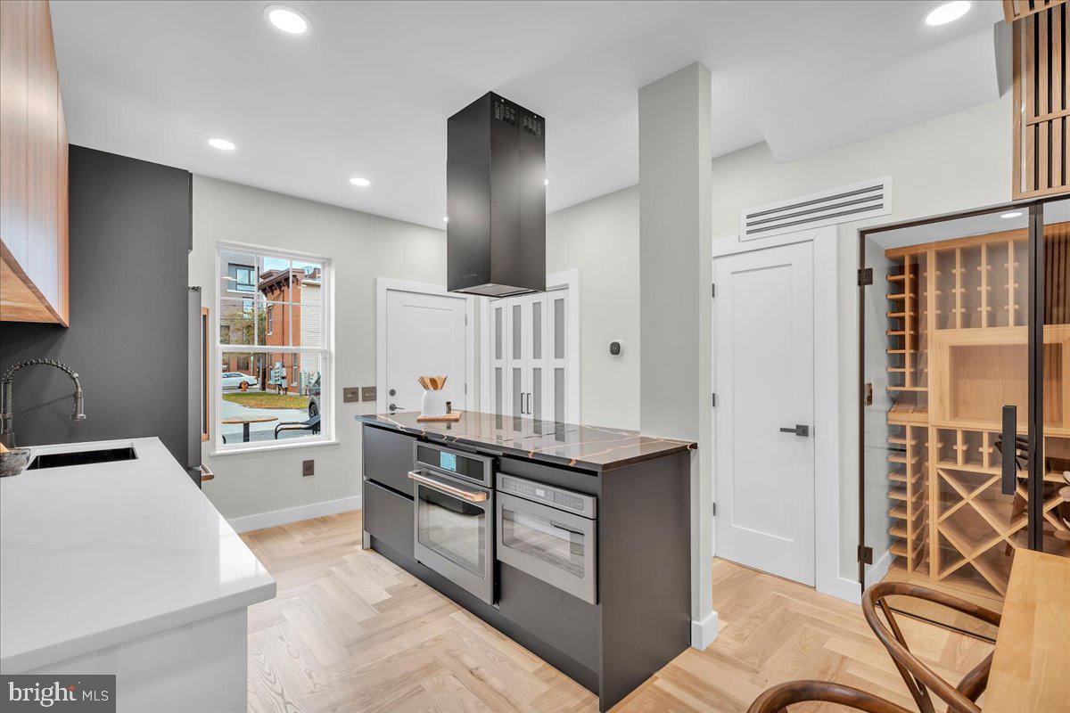 1227 Clymer Street Philadelphia, PA 19147 - Photo 14 of 37 a kitchen with stainless steel appliances granite countertop a stove and a sink