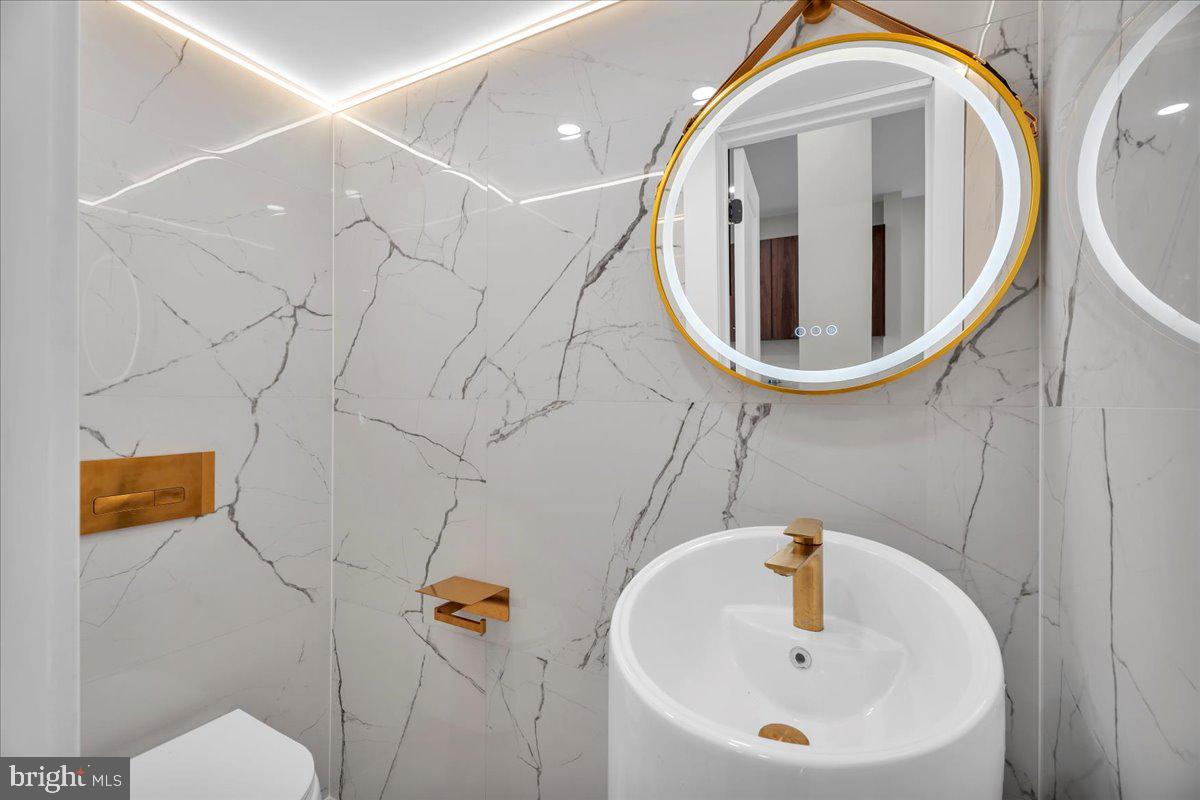 1227 Clymer Street Philadelphia, PA 19147 - Photo 15 of 37 a bathroom with a sink and mirror