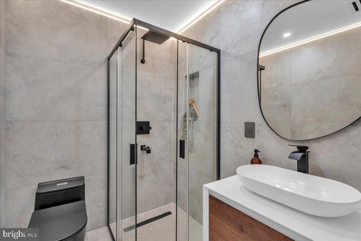 1227 Clymer Street Philadelphia, PA 19147 - Photo 18 of 37 a bathroom with a sink a toilet and shower