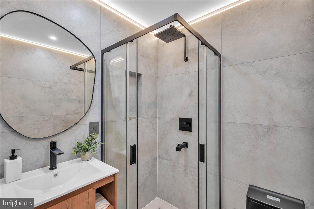 1227 Clymer Street Philadelphia, PA 19147 - Photo 21 of 37 a bathroom with a sink and a mirror