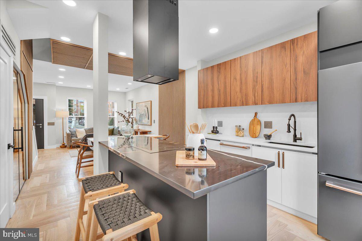 1227 Clymer Street Philadelphia, PA 19147 - Photo 10 of 37 a kitchen with a sink stainless steel appliances and cabinets