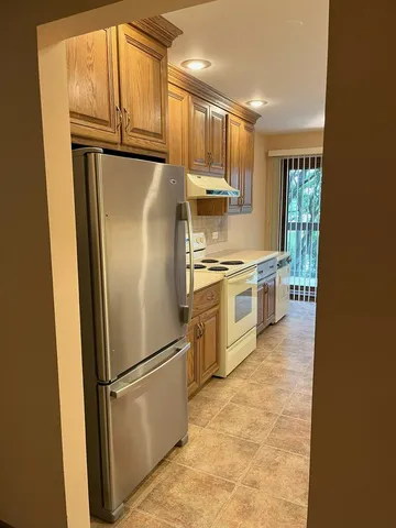 a kitchen with stainless steel appliances granite countertop a refrigerator a stove a sink dishwasher and a refrigerator