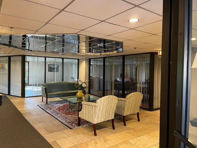 a view of a balcony with furniture and wooden floor