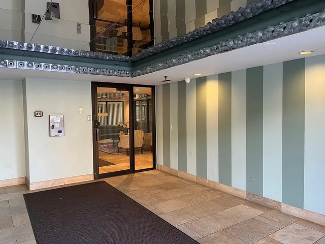 a view of a hallway with wooden floor and entryway