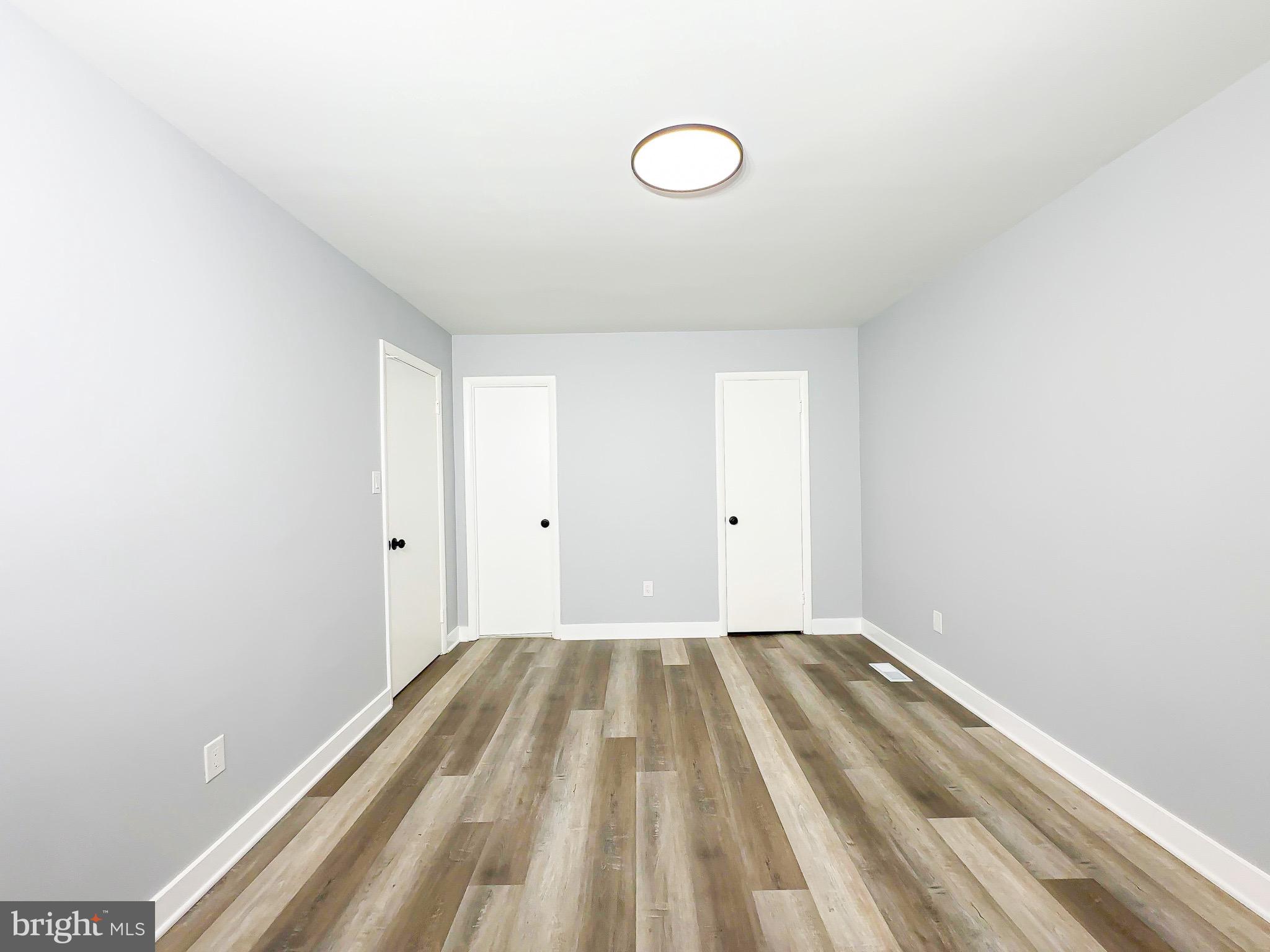 10167 Scotch Hill Drive, Unit 283 Upper Marlboro, MD 20774 - Photo 15 of 22 a view of a room with wooden floor and white walls