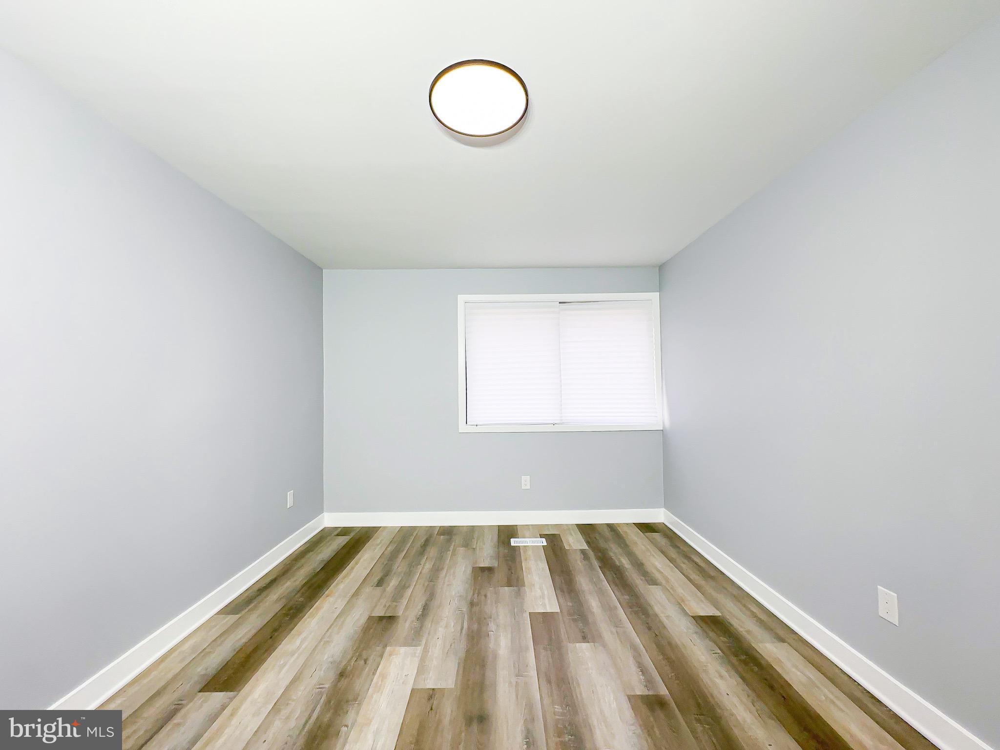 10167 Scotch Hill Drive, Unit 283 Upper Marlboro, MD 20774 - Photo 16 of 22 a view of a room with wooden floor and window