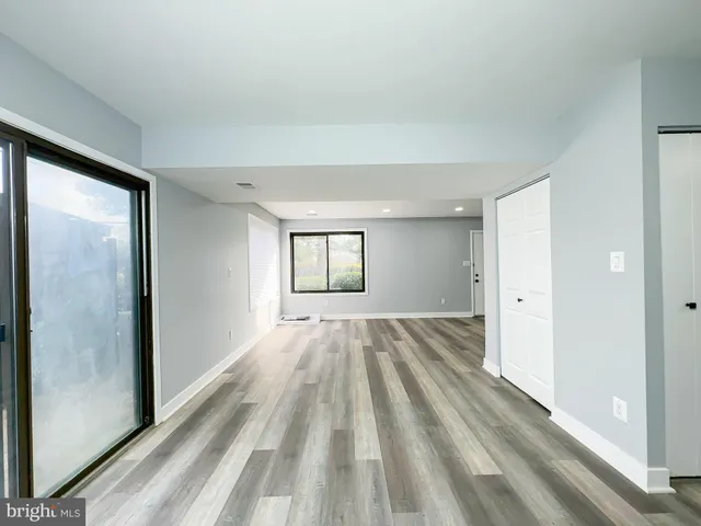 a kitchen with a refrigerator and white cabinets