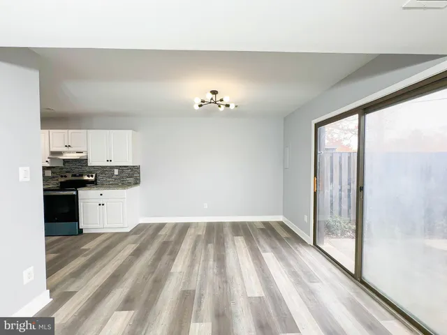 a kitchen with a sink a refrigerator a white and grey cabinets