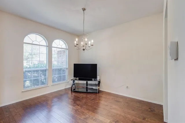 a view of room with wooden floor and window