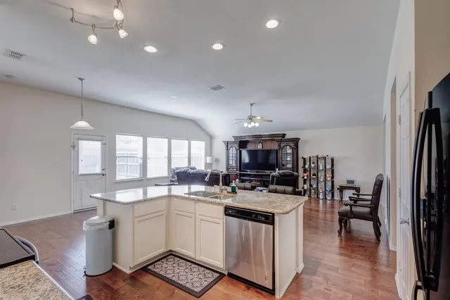 a kitchen with cabinets a sink and appliances