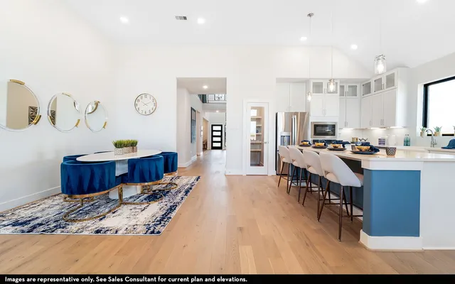 a living room with stainless steel appliances kitchen island granite countertop furniture a rug and a view of kitchen