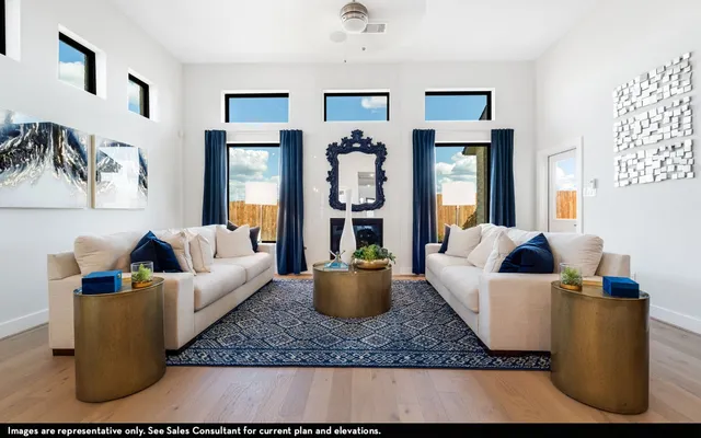 a living room with furniture and painting on the wall