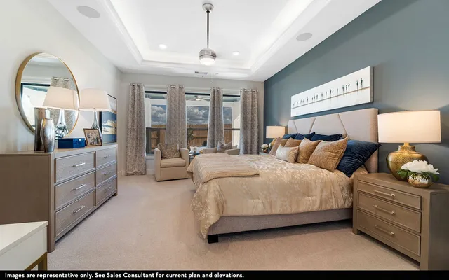 a spacious bedroom with a bed and a chandelier