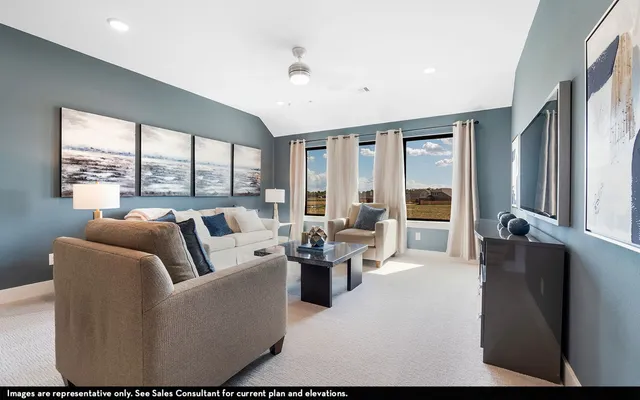 a living room with furniture and large windows