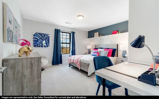 a bedroom with two beds and a dresser