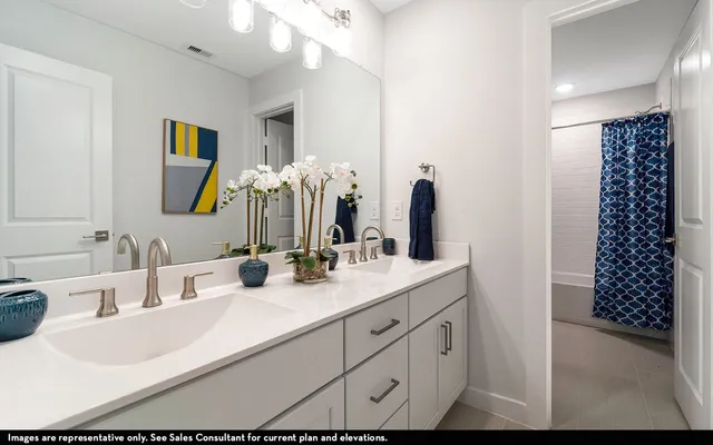 a bathroom with a double vanity sink mirror and