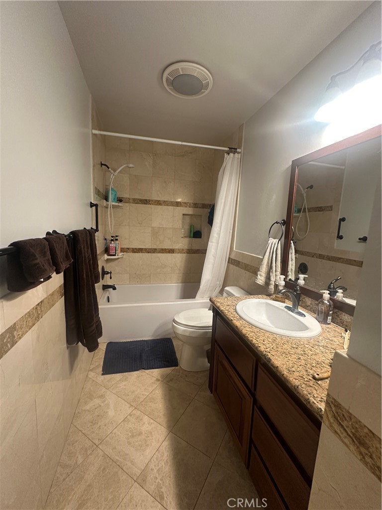 22161 James Alan Circle Chatsworth, CA 91311 - Photo 3 of 3 a bathroom with a granite countertop sink a toilet and shower