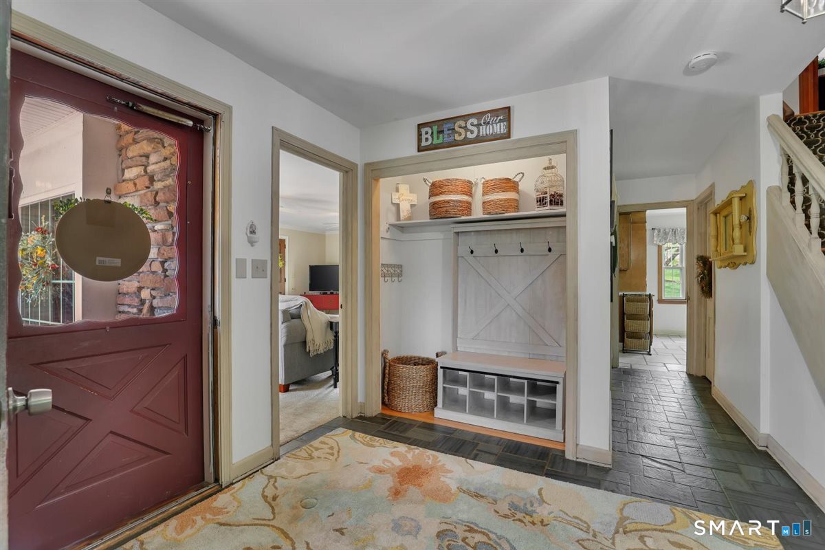 72 Old Post Road Wethersfield, CT 06109 - Photo 2 of 40 a view of a hallway with wooden floor and windows