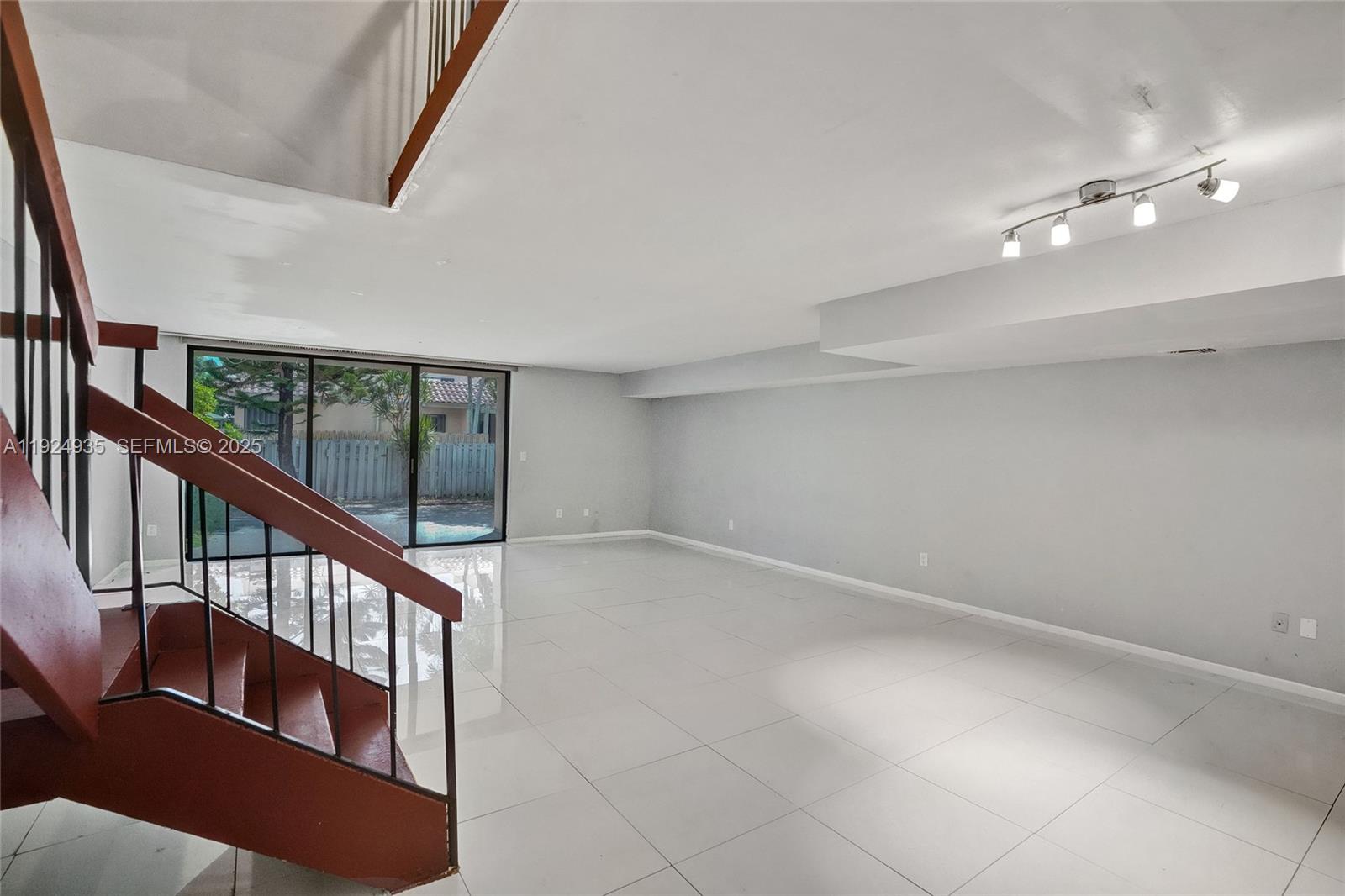 20607 Northeast 7th Court Miami, FL 33179 - Photo 13 of 49 a view of an empty room with wooden floor