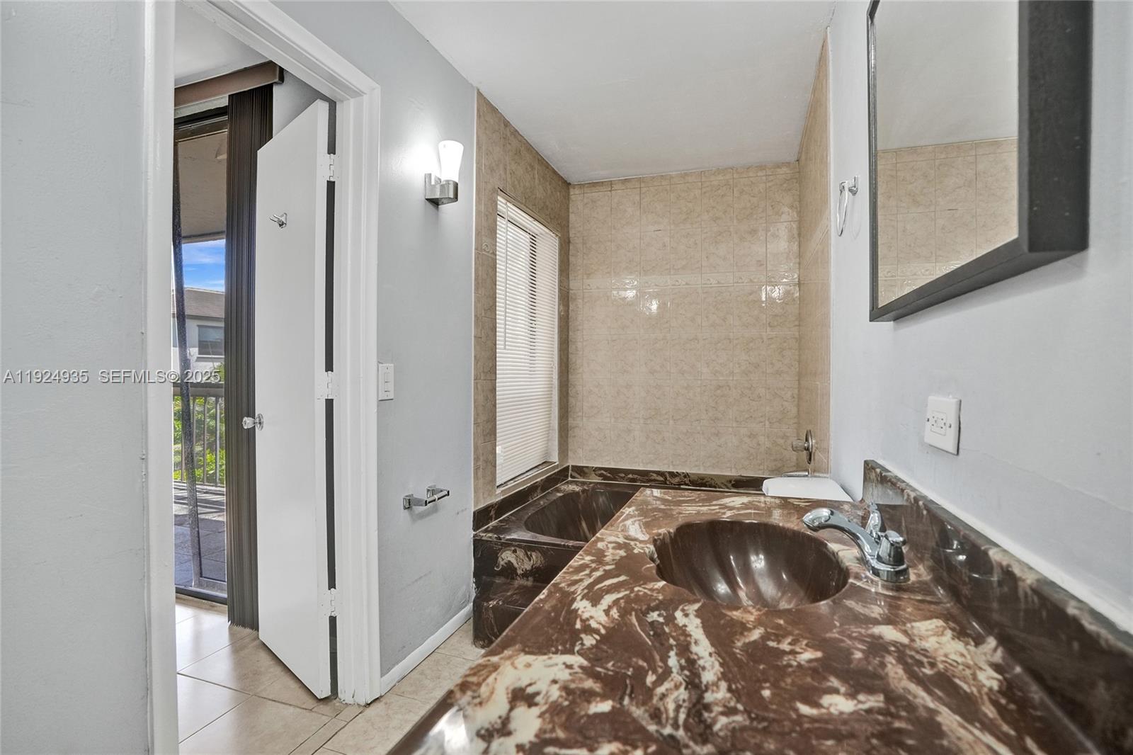 20607 Northeast 7th Court Miami, FL 33179 - Photo 24 of 49 a bathroom with a bathtub and a shower