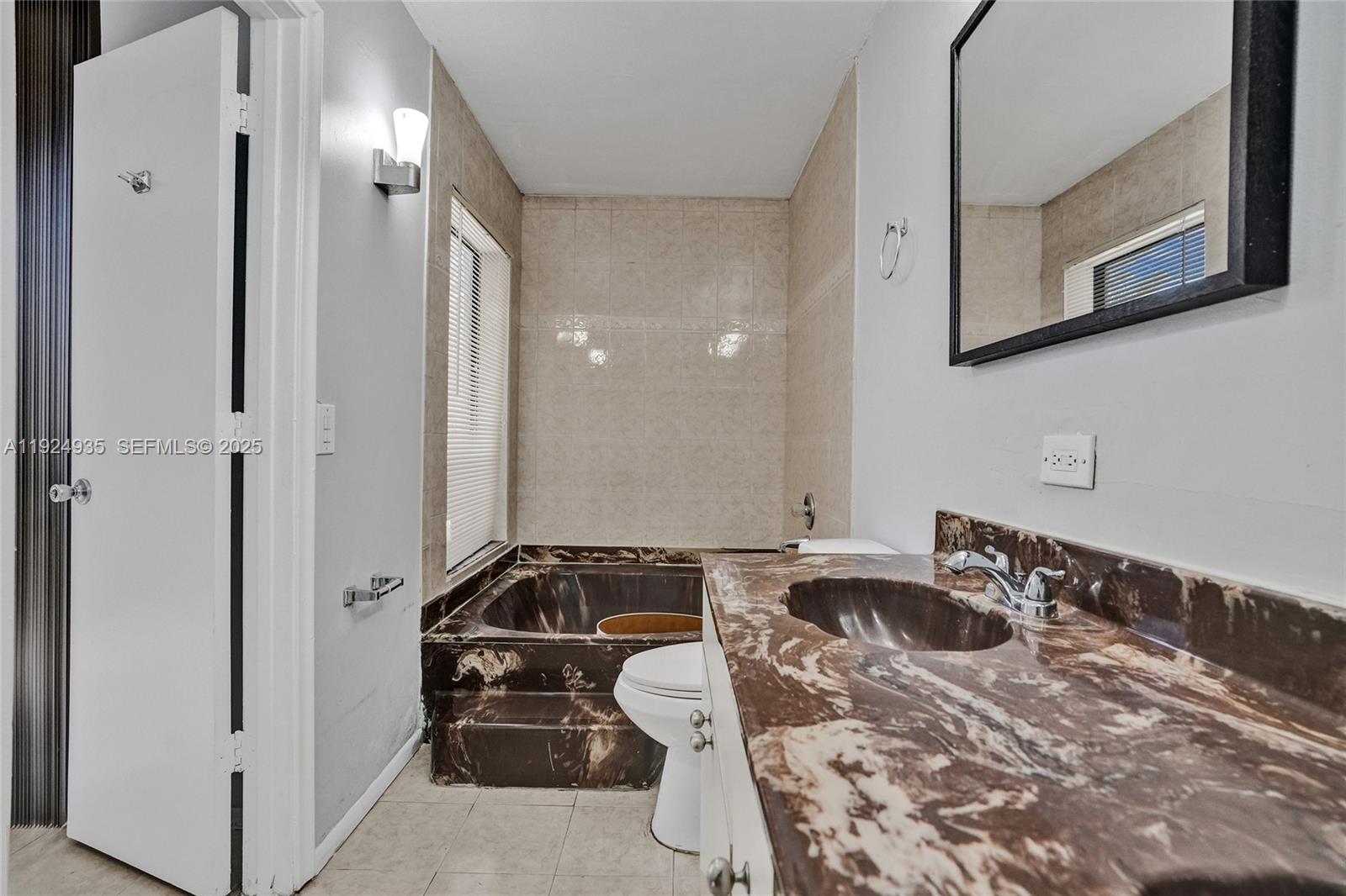 20607 Northeast 7th Court Miami, FL 33179 - Photo 25 of 49 a bathroom with a sink and a mirror