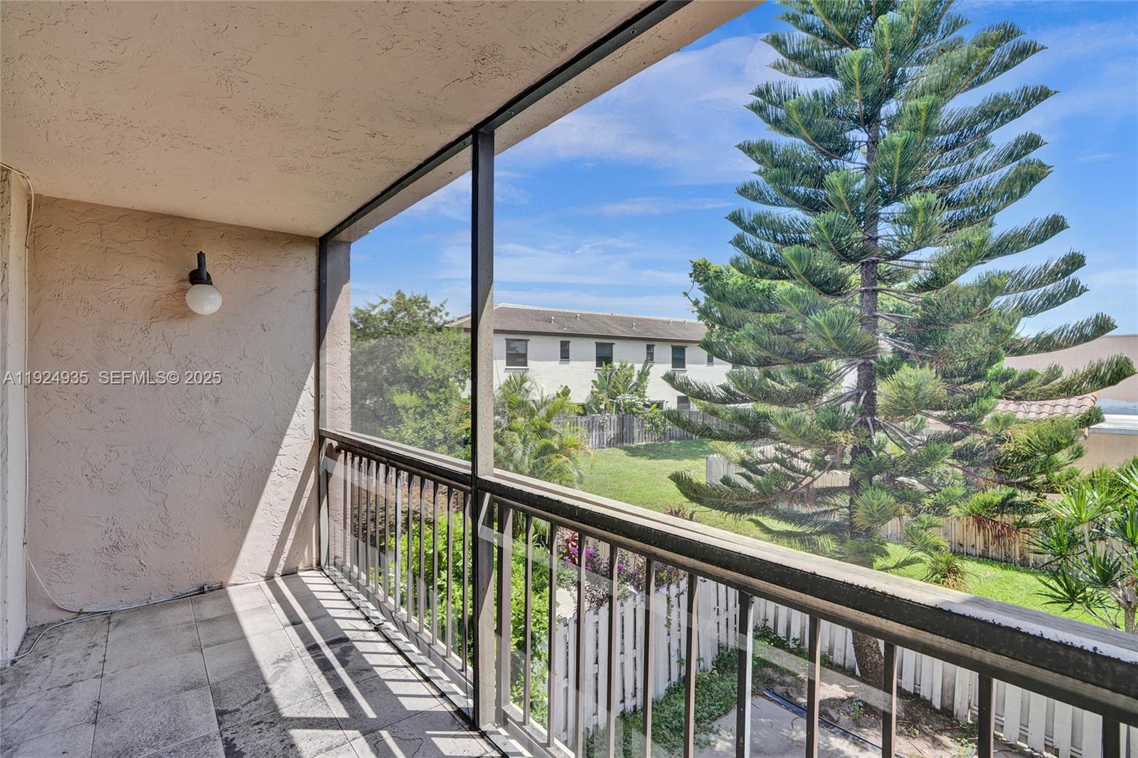 20607 Northeast 7th Court Miami, FL 33179 - Photo 26 of 49 a view of a balcony with a tree