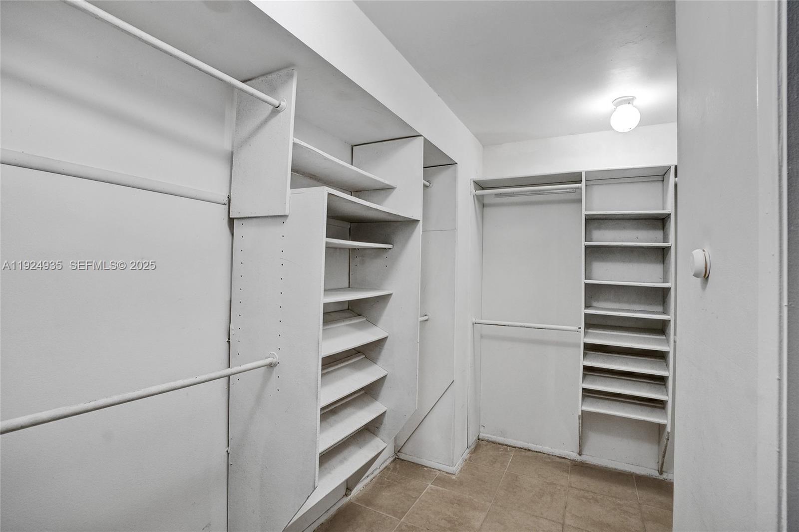 20607 Northeast 7th Court Miami, FL 33179 - Photo 28 of 49 a view of walk in closet with empty racks