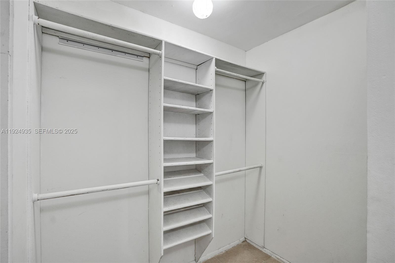 20607 Northeast 7th Court Miami, FL 33179 - Photo 29 of 49 a view of walk in closet with empty racks